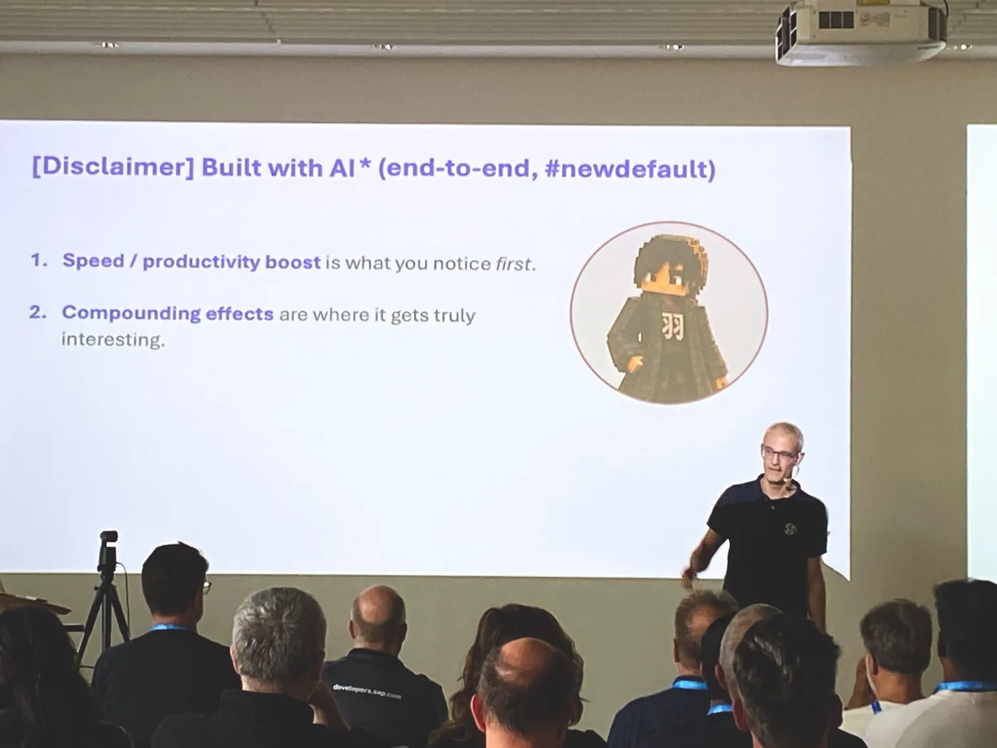 Matthias Steiner mid-sentence in front of his 'Built with AI' slide