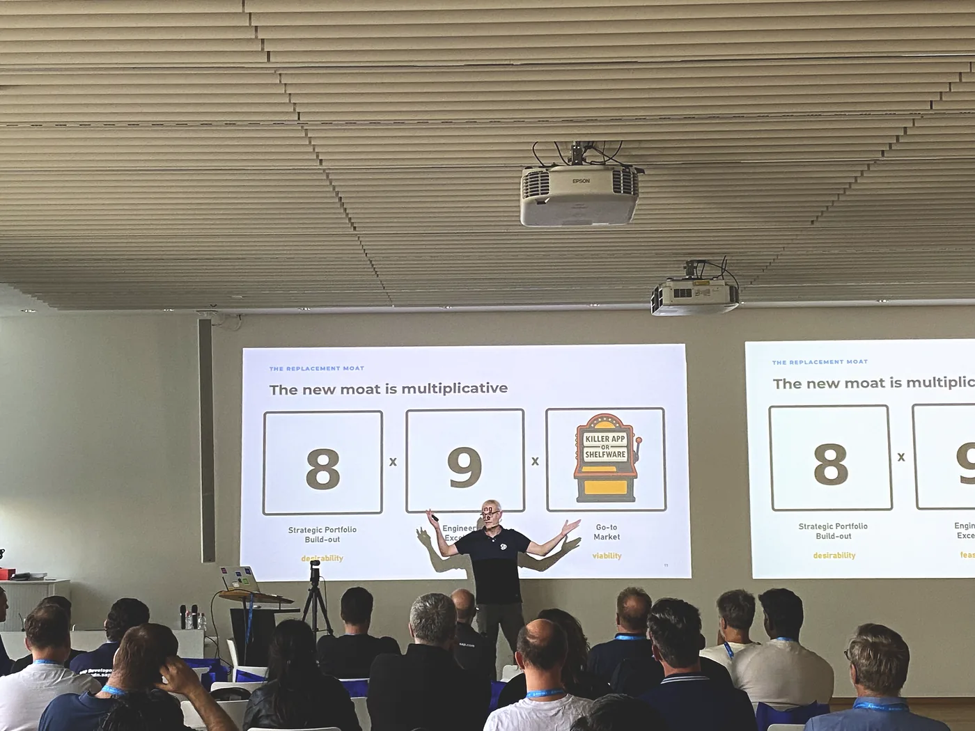 Matthias Steiner mid-gesture in front of the closing slides